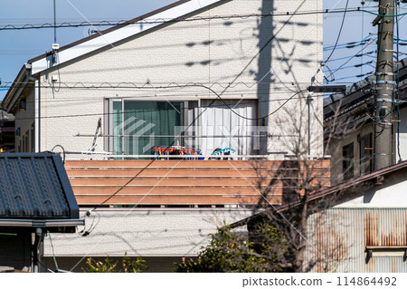 Two-storey detached house with a sloping roof Two-storey detached house with a sloping roof 114864492