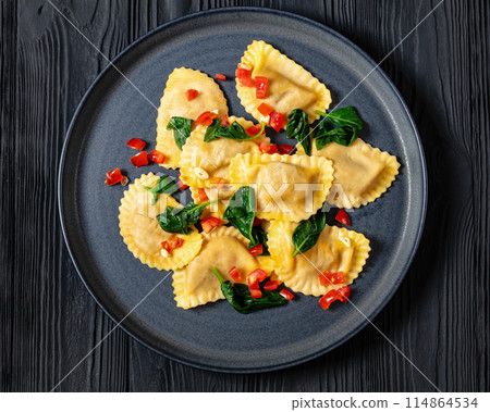italian pasta mezzelune on a plate, top view italian pasta mezzelune on a plate, top view 114864534