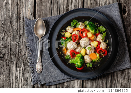 chicken meatball soup with vegetables in a bowl 114864535