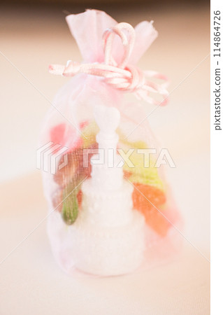 Pink Organza Bag with Candle and Flower Petals perfect gift for a romantic occasion 114864726