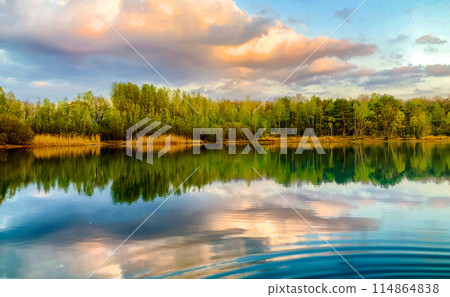 Natures beauty in serene lake, lush trees, and dramatic sky, creating a tranquil landscape Natures beauty in serene lake, lush trees, and dramatic sky, creating a tranquil landscape 114864838