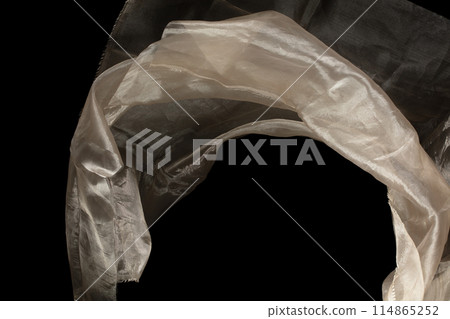 Yellow gold organza fabric flying in curve shape, Piece of textile Yellow gold organza fabric throw fall in air. Black background isolated, dark shading environment Yellow gold organza fabric flying in curve shape, Piece of textile Yellow gold organza fabric throw fall in air. Black background isolated, dark shading environment 114865252