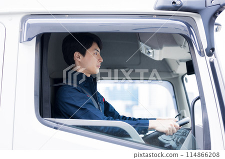Man sitting in the driver's seat of a truck 114866208