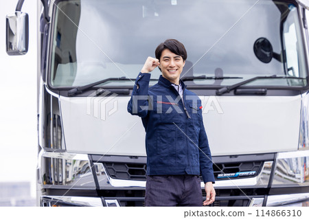 Truck driver standing in front of the truck 114866310