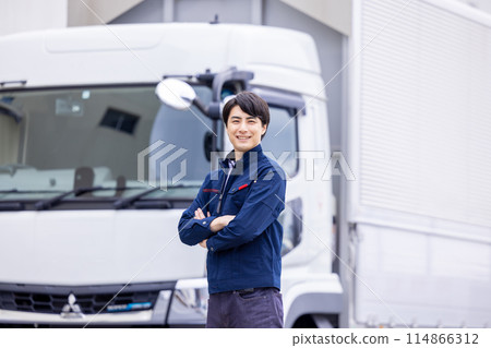 Truck driver standing in front of the truck 114866312