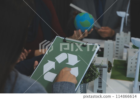 Business people having consultation about wind energy at company office. Business team discussing about windmill and alternative green energy. Executive meeting at modern office 114866614