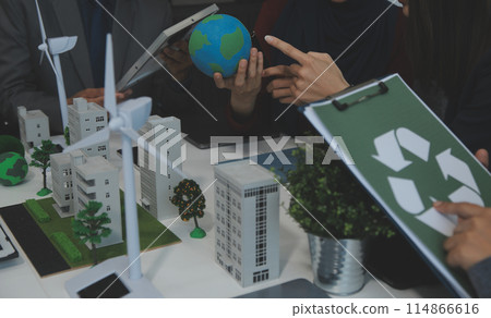 Business people having consultation about wind energy at company office. Business team discussing about windmill and alternative green energy. Executive meeting at modern office 114866616