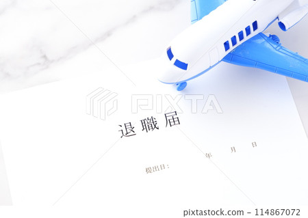 A resignation letter and an airplane placed on an office desk, representing the image of leaving the company and taking flight to freedom A resignation letter and an airplane placed on an office desk, representing the image of leaving the company and taking flight to freedom 114867072
