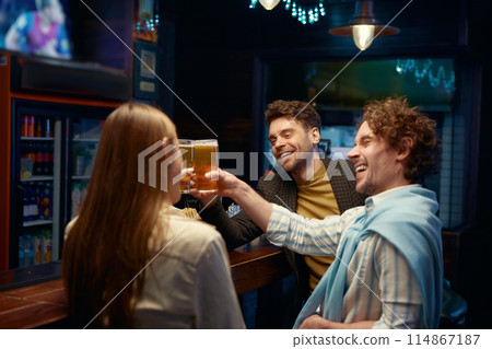 Guys employee congratulating female coworker while rest in bar 114867187