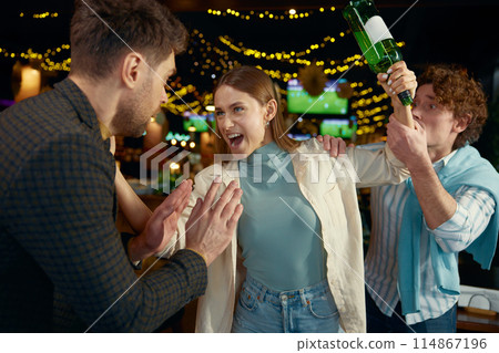Drunk aggressive woman attacking guy feeling angry and furious Drunk aggressive woman attacking guy feeling angry and furious 114867196