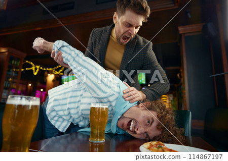Drunk friends football fans fighting at sports bar due to quarrel Drunk friends football fans fighting at sports bar due to quarrel 114867197