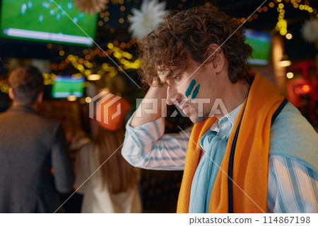 Frustrated sad man football fan touching head due to loss of favorite team Frustrated sad man football fan touching head due to loss of favorite team 114867198