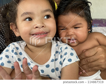 Portrait of two happy Asian little girls smiling Portrait of two happy Asian little girls smiling 114867319