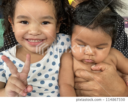 Portrait of two happy Asian little girls smiling Portrait of two happy Asian little girls smiling 114867330
