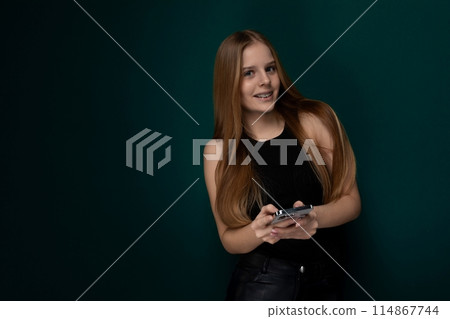 Woman With Long Red Hair Holding a Cell Phone Woman With Long Red Hair Holding a Cell Phone 114867744