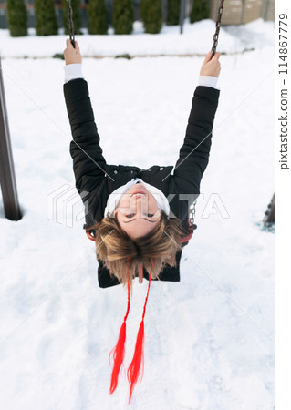European woman having fun and fooling around outdoors in winter 114867779