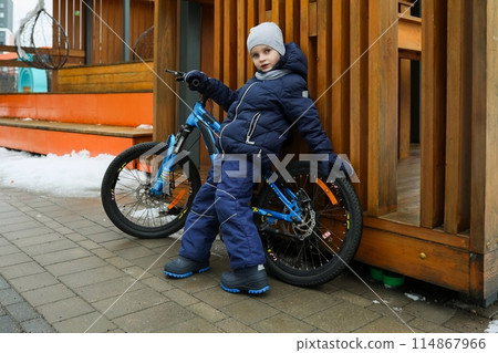 Child boy likes to spend time riding a bike Child boy likes to spend time riding a bike 114867966