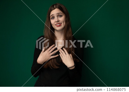 Woman Standing in Front of Green Wall Woman Standing in Front of Green Wall 114868075