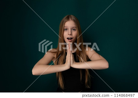 Young Girl Making a Surprised Face With Her Hands 114868497