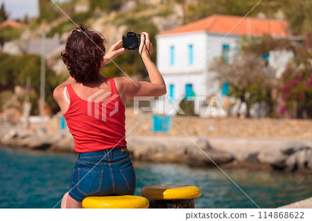 Tourist take photo in greek marina 114868622