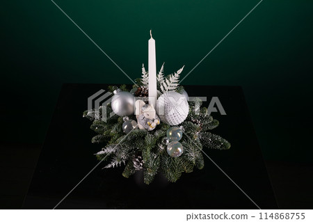 Lit Candle on Christmas Centerpiece 114868755