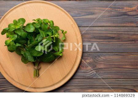 Fresh mint on Cutting board table, top view. Flat lay Space for text Fresh mint on Cutting board table, top view. Flat lay Space for text 114869329