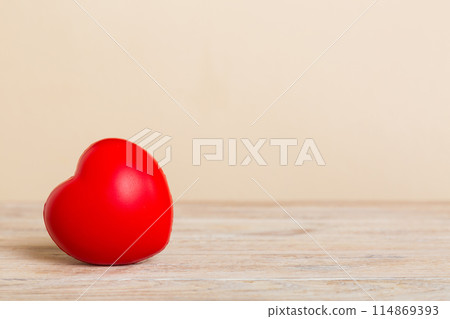 gift box with red bow and red heart on colored background. Perspective view. Flat lay gift box with red bow and red heart on colored background. Perspective view. Flat lay 114869393