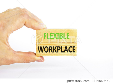 Flexible workplace symbol. Concept words Flexible workplace on beautiful wooden block. Beautiful white paper background. Businessman hand. Business Flexible workplace concept. Copy space. Flexible workplace symbol. Concept words Flexible workplace on beautiful wooden block. Beautiful white paper background. Businessman hand. Business Flexible workplace concept. Copy space. 114869459