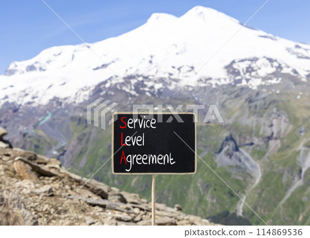 SLA service level agreement symbol. Concept words SLA service level agreement on beautiful yellow blackboard. Beautiful Elbrus background. Business SLA service level agreement concept. Copy space. 114869536