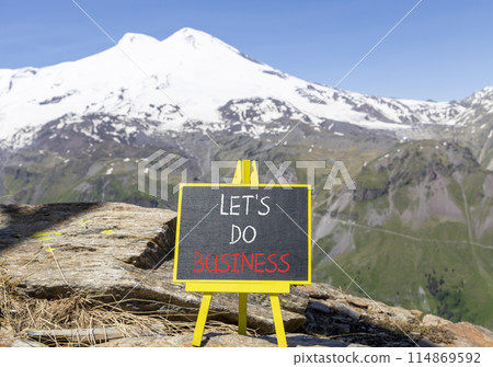 let is do business symbol. Concept words let is do business on beautiful black chalk blackboard. Beautiful mountain Elbrus background. let is do business concept. Copy space. 114869592