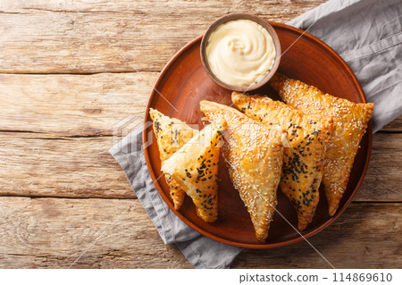 Chicken puffs with cheese and herbs served with dipping sauce close-up in a plate. Horizontal top view 114869610