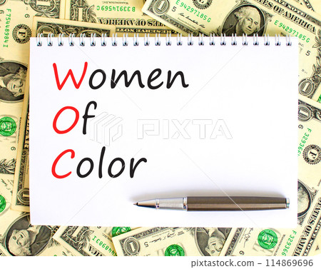 WOC women of color symbol. Concept words WOC women of color on beautiful white note. Dollar bills. Beautiful dollar bills background. Business WOC women of color social issues concept. Copy space. 114869696