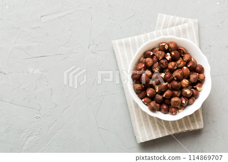 Wooden bowl full of hazelnuts on table background. Healthy eating concept. Super foods 114869707