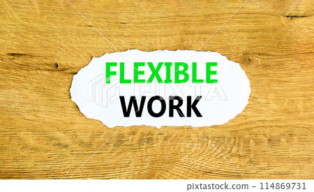 Flexible work symbol. Concept words Flexible work on beautiful white paper. Beautiful wooden wall background. Business Flexible work concept. Copy space. 114869731