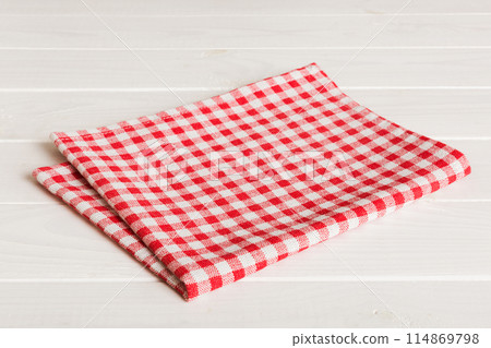 top view with red empty kitchen napkin isolated on table background. Folded cloth for mockup with copy space, Flat lay. Minimal style 114869798