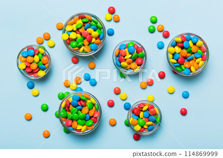 different colored round candy in bowl and jars. Top view of large variety sweets and candies with copy space 114869999