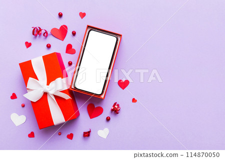 Opened gift box with ribbon and phone on color background, top view. Blank open box packaging mockup , Template for your design - branding mockup Opened gift box with ribbon and phone on color background, top view. Blank open box packaging mockup , Template for your design - branding mockup 114870050