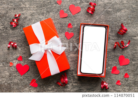 Opened gift box with ribbon and phone on color background, top view. Blank open box packaging mockup , Template for your design - branding mockup Opened gift box with ribbon and phone on color background, top view. Blank open box packaging mockup , Template for your design - branding mockup 114870051