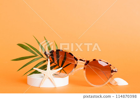 sunglasses with seashell lying on table background. Sunglasses on summer background. Top view flat lay with copy space for text sunglasses with seashell lying on table background. Sunglasses on summer background. Top view flat lay with copy space for text 114870398