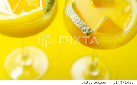 A holiday cocktail based on vodka, liqueur and fresh melon, a refreshing drink prepared by a bartender A holiday cocktail based on vodka, liqueur and fresh melon, a refreshing drink prepared by a bartender 114871455