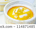 A dessert with a yellow center and white powdered sugar on top 114871485