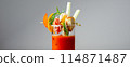 A glass of Bloody Mary drink with a celery spear and an orange slice on top 114871487