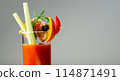 A glass of Bloody Mary drink with a celery spear and an orange slice on top 114871491