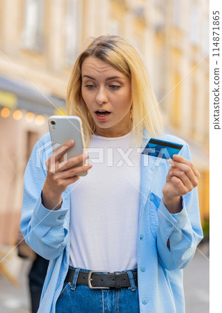 Shocked woman trying to pay online shopping smartphone blocked credit card lack of money balance 114871865