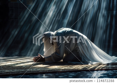 A Muslim man prays in a mosque. He kneels on a prayer mat, hands raised in devotion. The act of prayer and faith. Generative AI. 114872288