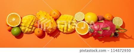 Set of tropical fruit on orange background, top view 114872930