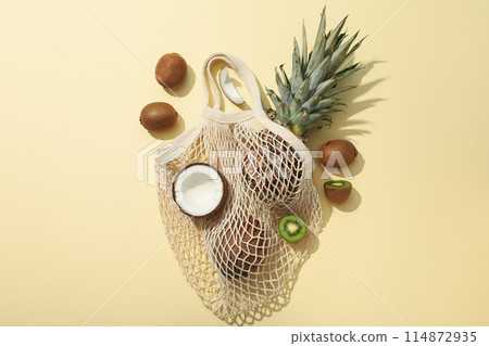 Set of tropical fruit in bag on beige background, top view 114872935
