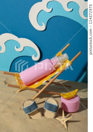 Tanning agents on a beach lounger, against the background of waves. 114872978
