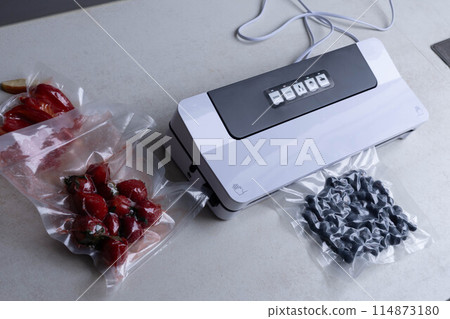 fresh berries in a vacuum bag with a vacuumiser machine 114873180