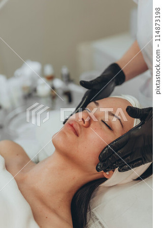 woman at the cosmetologist. She has problem skin and acne. woman at the cosmetologist. She has problem skin and acne. 114873198